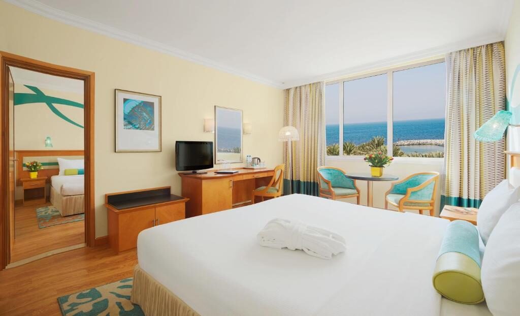 Room with a king bed and a view of the Arabian Gulf