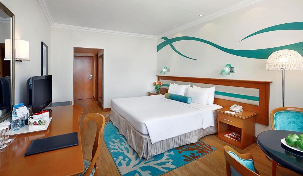 Bright resort room with seating area and desk